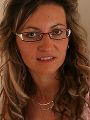 Mature in glasses appart her legs and shows pussy